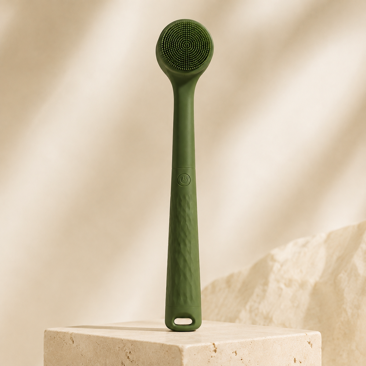 Green Bristlewell electric body brush standing upright against a plain warm backdrop
